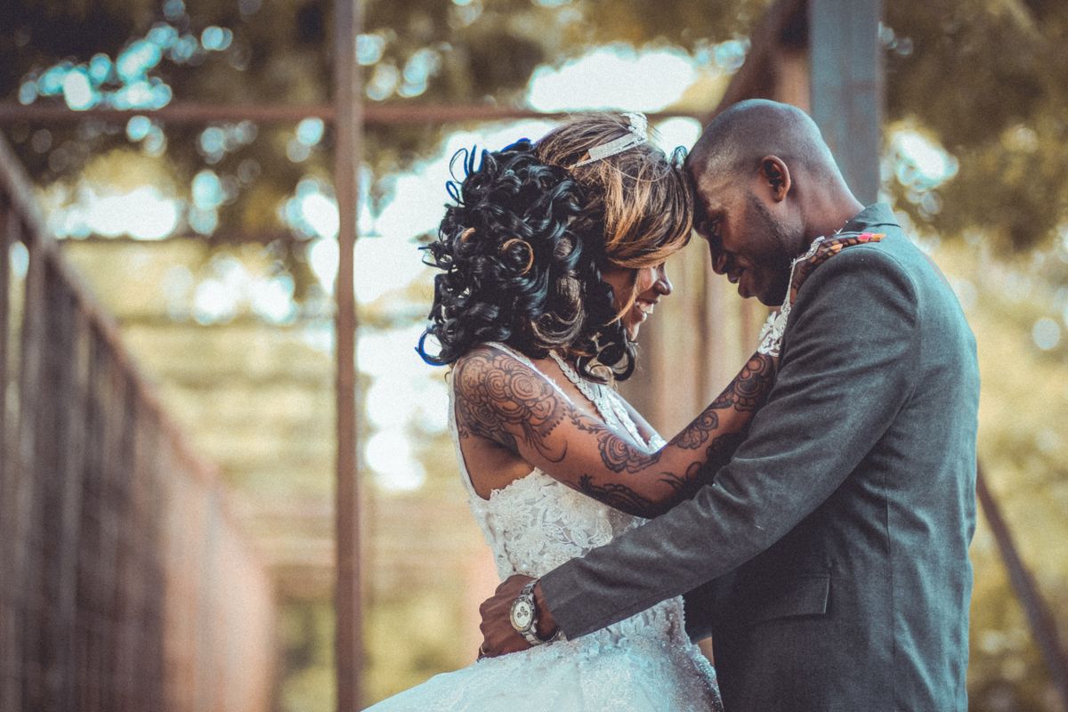 A bride and groom sharing an embrace at their wedding in Kenya